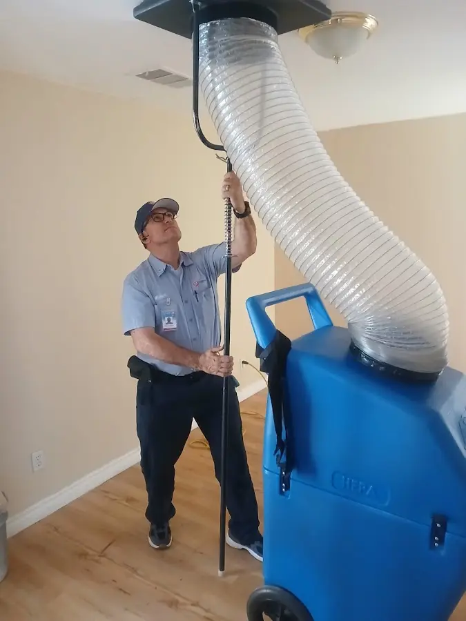 Furnace Tune-Up technician using HEPA equipment in Herriman